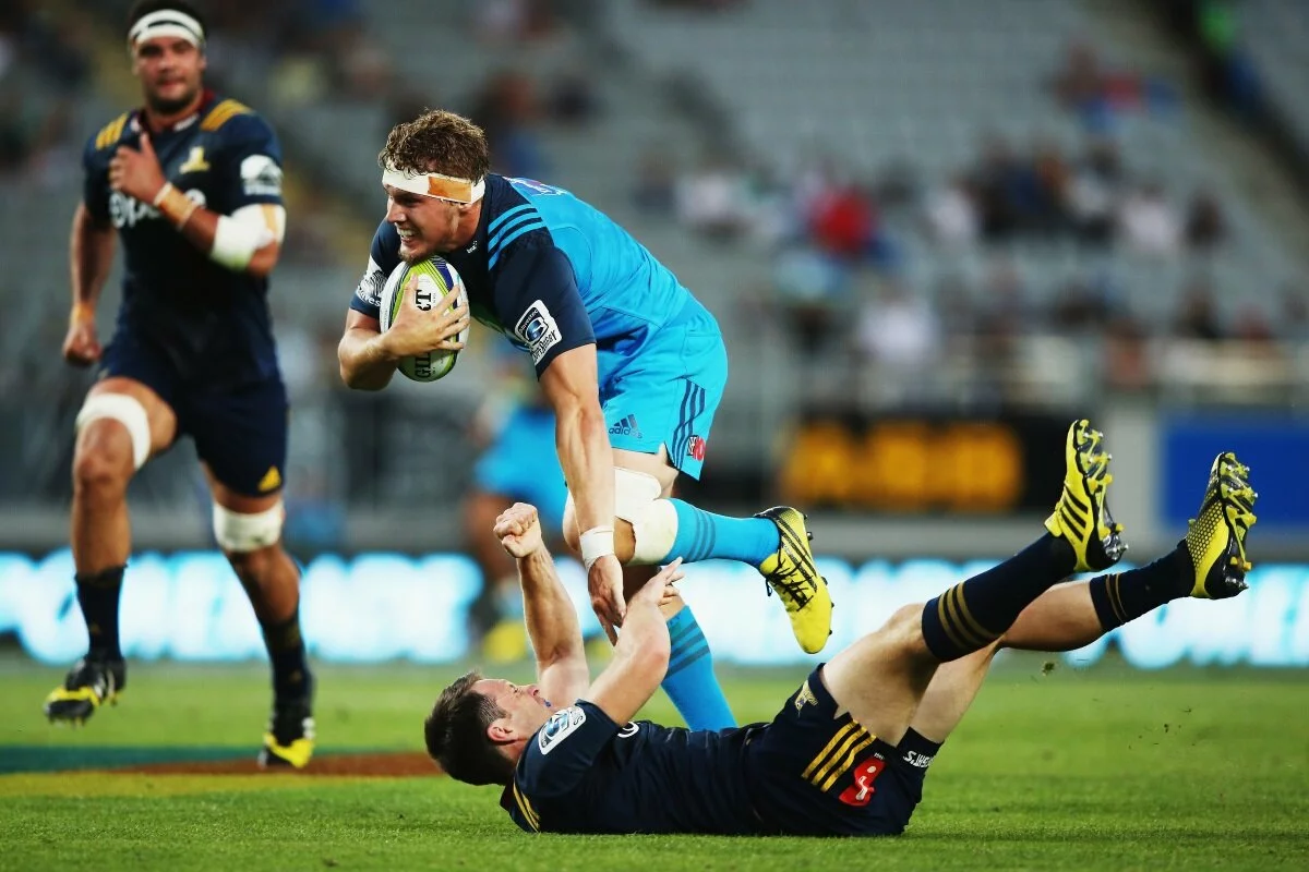 blake_gibson_of_the_blues_charges_over_ben_smith_o_56d5c51f34